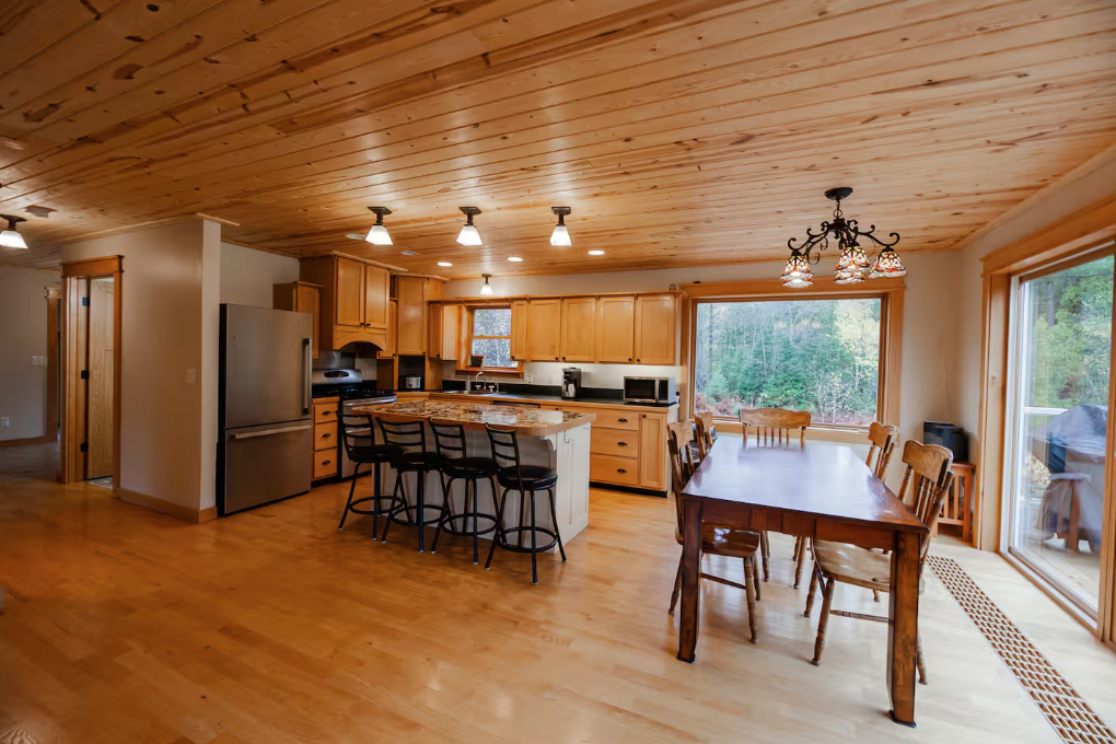 Second floor kitchen leads to deck overlooking campfire pit